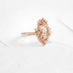 Round rose cut diamond focal: 3mm, SI clarity. This design features a closed basket setting on a delicate 1.2mm band—available in 14k solid yellow, white or rose gold. The setting is accented by twenty-five (1-2.2mm) round white diamonds. All accent diamonds are SI clarity and G+ color. We handcraft each piece with responsibly sourced 14k gold and ethically sourced stones. Delicate Crystal Ring With Rose Cut Diamonds For Wedding, Delicate Rose Cut Diamond Crystal Wedding Ring, Delicate Crystal Wedding Ring With Rose Cut Diamonds, Elegant Rose Cut Diamond Crystal Ring, Delicate Diamond Ring With Rose Cut Diamonds, Heirloom Style Rose Gold Cluster Ring, Heirloom Cluster Ring With Rose Cut Diamonds For Promise, Heirloom Rose Gold Cluster Ring With Rose Cut Diamonds, Heirloom Rose Cut Diamond Promise Ring