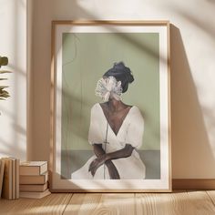 a framed photograph of a woman with a flower in her hair sitting on a table