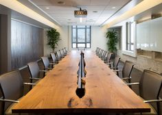 an empty conference room with wooden tables and chairs