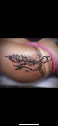 a woman's arm with a feather and flower tattoo on the left side of her body