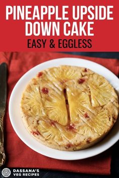 a pineapple upside down cake on a plate with a knife and fork next to it