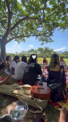 a group of people sitting under a tree