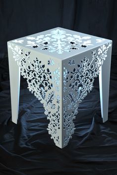 an intricately designed table sits on a black background