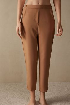 Full-length trousers featuring two pockets, faux back pocket and covered elasticated waist. Brown Tapered Leg Bottoms, Brown Tapered Leg Bottoms For Business Casual, Brown Tapered Leg Business Casual Bottoms, Elegant Workwear Bottoms With Patch Pockets, Brown Bottoms With Welt Pockets, Elegant High-waisted Pants With Patch Pockets, Chic Pants With Patch Pockets And Straight Hem, Stretch Brown Pants With Pockets, Brown Stretch Pants With Pockets