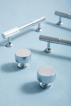 several metal knobs and handles on a blue surface