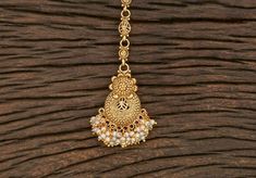 Plain Gold Tikka Antique Maang Tikka Height = 155 mm || Width = 34 mm Plain Gold Tikka Antique Maang Tikka Whether you are the bride or sassy bridesmaid, no lehenga is complete without a maang tikka. This Kundan pearl maang tikka is perfect to steal the show with its elegance . The meticulous attention paid to the craftsmanship makes it an epitome of jewelry inspiration. 100% Satisfaction Guarantee: Long Lasting Plating, High-Quality Stones. Gifting: This charming maang tikka comes in a beautifu Intricate Design Tikka For Diwali Gift, Temple Jewelry Tikka With Intricate Design As Gift, Diwali Gift Round Tikka, Gold Tikka For Navratri Gift, Traditional Tikka With Latkans As Gift, Festive Tilla Tikka As Gift, Festive Tikka With Tilla As A Gift, Festive Tikka With Tilla Detailing As Gift, Festive Tikka With Tilla Detailing