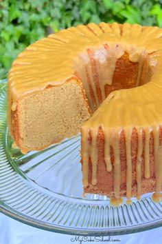 a bundt cake on a glass platter with a slice cut out and ready to be eaten