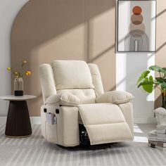 a white recliner chair sitting in a living room next to a vase with flowers