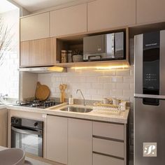 a kitchen with a sink, stove and microwave