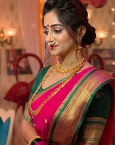 a woman in a pink and green sari