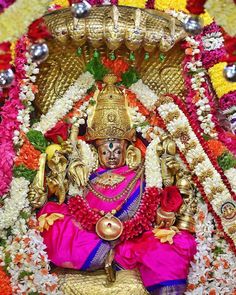 an idol is displayed in front of flowers