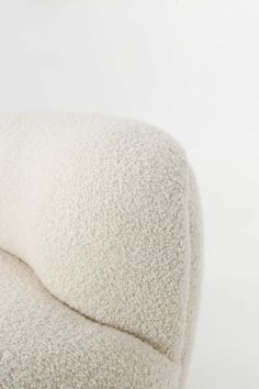 a close up of a white chair with a pillow on it's backrest