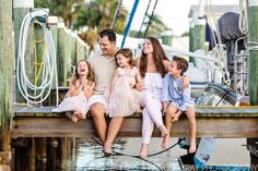 a family sitting on a dock together