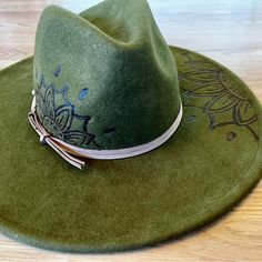 This Beautiful Green Wool Felt Fedora Is A Must-Have Addition To Your Wardrobe. The Handmade Floral Mandala Design Is Custom Made And Adds A Touch Of Uniqueness To The Hat. The Wide Brim Is Perfect For Sunny Days And The Wool Burned Accents Give It A Rustic Touch. The Hat Is From The Universal Thread Brand And Is One Size Fits All. It Is Made Of High-Quality Wool Material And Is Perfect For Women Who Love To Accessorize. Personalized With Custom Art Making It Even More Special. Get Ready To Turn Heads With This Gorgeous Hat! Used In Like New Condition Green Brimmed Felt Hat For Winter, Bohemian Green Felt Hat With Flat Brim, Adjustable Wide Brim Green Felt Hat, Artisan Green Hat With Flat Brim, Handmade Green Brimmed Felt Hat, Felt Fedora, Universal Thread, Green Wool, Wide Brimmed Hats