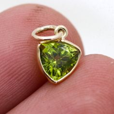 14k Yellow Gold Pendant / Green Peridot Gemstone Pendant / Gold Jewelry Pendant / Yellow Gold Jewelry Pendant / Valentine Day Gift  ✦ GEMSTONE DETAILS✦  ✦ Gemstone : Peridot  ✦ Gemstone Type : Natural ✦ Gemstone Shape : Trillion    ✦ Gemstone Color : Green  ✦ Citrine Weight : 0.65 CT ✦ Gemstone Cut : Trillion    ✦ Gemstone Grade : Excellent ✦ METAL DETAILS✦  ✦ Metal:  14k Yellow Gold ✦ Pendant Size : 11x6 mm  ✦ Pendant Weight : 0.37 gm ✦ Setting: Bezel Setting ✦ Pendant Box: Yes ✦ CUSTOMISATION DETAILS✦ We can customize any piece of fine jewelry. You can simply message us on Etsy or drop a text at +91-7357229656 (WhatsApp/I Message) to let us know about all the customization you want. Customization can include : ✦ The Gemstone: This Earring can be made in Emerald, Ethiopian Opal, Rainbow M Green Charms Jewelry For Anniversary, Gift Yellow Gold Peridot Gemstones, Green Citrine, Gold Pendant Jewelry, Gold Armband, Yellow Gold Jewelry, Personalized Pendant, Bezel Pendant, Peridot Gemstone