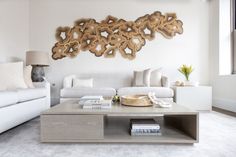 Coffee Table Styling Ideas in a Modern light, bright, white living room design with earthy pops of brown Joshua Abarbanel, Cardboard City, Design Milk