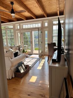 a living room filled with furniture and lots of windows