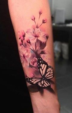 a woman's arm with a butterfly and flowers on it