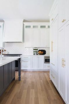 the kitchen is clean and ready for us to use it's white cabinetry