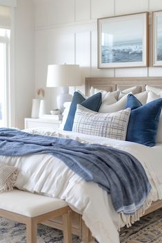 a bed with blue and white pillows on it