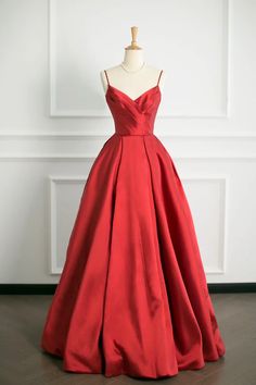 Make a bold statement at your next formal event with this Elegant Scarlet Satin Ball Gown. Designed to captivate, the gown features a sleek, fitted bodice with delicate spaghetti straps, creating a stunning silhouette that flatters the shoulders and neckline. The rich scarlet hue is both passionate and timeless, ensuring youll draw every eye in the room.The gowns waistline gracefully cinches to accentuate your figure before spilling into a luxuriously voluminous skirt. Crafted from high-quality satin, the material boasts a subtle sheen that catches the light with every movement, enhancing the gowns dramatic appeal. The full skirt adds a touch of classic romance and moves beautifully, making it perfect for dancing the night away.This ball gowns perfect blend of modern sophistication and cla Red Satin Prom Dress, Prom Dress Simple, Prom Dresses Simple, A Line Prom Dress, Satin Ball Gown, Long Prom Dresses, Dress Simple, Custom Size Dresses, A Line Prom Dresses