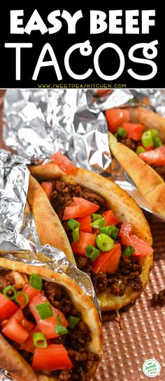 easy beef tacos with tomatoes and green onions in foil wrap on a table top