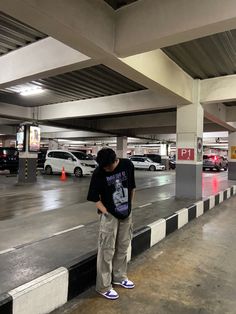 a man standing on the edge of a parking garage