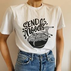 Send Noods Ramen Bowl Humor Graphic Tee Brand New To Our In House Collection Features 100% Quality Cotton, Crewneck, Relaxed Unisex Fit, And All Over White T-Shirt With 'Send Noods' + Ramen Bowl & Chopsticks In Black. Size S-Xl Available - Please Message Me Your Size After Purchase. Model Is Wearing A Size M Tucked In. Retail Photography, Ramen Shirt, Send Noods, Long Shirt Women, Yellow Polo Shirt, Merch Ideas, Ramen Bowl, Blue Polo Shirts, Red Shorts