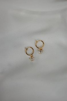 These earrings are made from gold plated cubic zirconia butterfly charms, dangling from huggie hoop closures. Both standard and clip on huggie hoops are available, all hypoallergenic and nickel free. Standard gold hoops are hypoallergenic and nickel free (18 karat gold plated). Clip on gold hoops are hypoallergenic and nickel free (18 karat gold plated). Please feel free to message me if you have any questions! Cubic Zirconia Huggie Earrings With Ear Wire As Gift, Butterfly Charm Huggie Earrings As Gift, Dainty Hypoallergenic Dangle Crystal Earrings, Butterfly Charm Drop Earrings As Gift, Butterfly Charm Drop Earrings For Gift, Tiny Dangle Cartilage Earrings Gift, Gift Butterfly Charm Huggie Earrings, Gold Huggie Earrings With Butterfly Charm, Dainty Butterfly Earrings For Everyday Wear