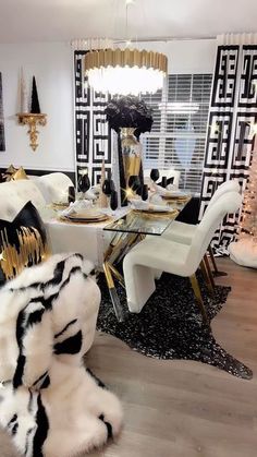 a black and white dining room with gold accents