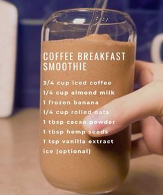 a hand holding a glass with coffee breakfast smoothie in it and instructions on how to make the drink