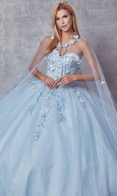 Here's a ball gown quinceañera dress that's worthy of royalty. Embellished by 3-D floral appliques, gorgeous embroidery embellishes the fitted bodice of this strapless sweetheart quince dress and trails down onto the poofy sparkling skirt. A matching sheer cape with additional flower accents adds a majestic touch to this glitter quince dress. For a princess-worthy look at your cumpleaños, wear this embroidered quinceañera dress with cape. Gown With Cape, Floral Ball Gown, Evening Gala, Debutante Ball, Full Tulle Skirt, Sparkle Skirt, Quince Dress, Bahama Blue, Usa Dresses