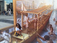 two children sitting on a boat in front of a mural