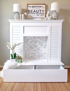 a white fireplace with two drawers underneath it