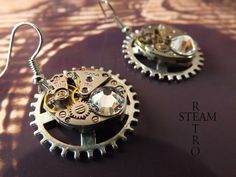 "Elegant Steampunkery! Vintage 17 jewel Watch mechanisms on a fixed gearwheel, featuring 2 stunning clear Swarovski Crystals. The findings are 925 Sterling silver. Lightweight, perfect for adding a touch of class to that steampunk, cosplay outfit, but understated enough to be used for everyday use! the choice is yours! Steamretro has a 100% feedback rating! When you buy from Steamretro you will receive a fantastic Handmade piece of jewelry, quite distinct from any other boutique! We offer FREE s Punk Style Round Earrings As Gift, Steampunk Metal Earrings For Gift, Silver Steampunk Earrings, Watch Mechanism, Earrings Gothic, Steampunk Watch, Steampunk Earrings, Steampunk Cosplay, Steampunk Jewelry