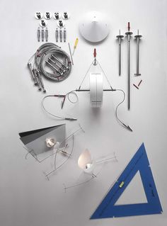 an assortment of electrical components are displayed on a white surface, including wires and tools