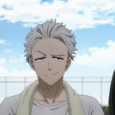 an anime character with grey hair and blue eyes looks at the camera while standing in front of a fence