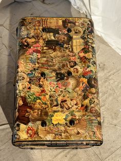 an old suitcase is covered with many different pictures and designs on it's side