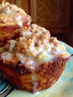 two muffins sitting on top of a blue and white plate next to each other