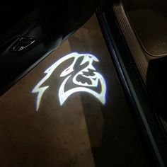 the floor is lit up with blue and white light from below it, as well as an image of a cat's head that appears to be projected on the floor