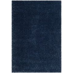 a blue rug on a white background with no one in it and the area is very shaggy