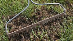 a fire hydrant laying in the grass next to a broken power cord and wire