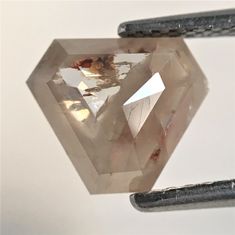 a close up of a diamond on a piece of metal