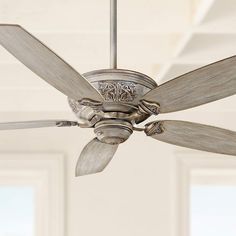 a ceiling fan in a room with white walls