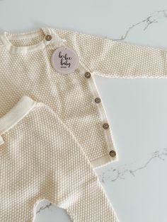 Get ready for cuteness overload with our baby sweater and pants set! Featuring a textured pattern, this long sleeve sweater has buttons on the side for easy dressing. The matching pants have an elastic waistband for a comfortable fit. Perfect for your little one's playful adventures! Cozy Playtime Sets For Fall, Beige Long Sleeve Sets With Buttons, Cream Long Sleeve Sets For Fall, Soft Knit Long Sleeve Sweater For Playtime, White Long Sleeve Sets With Button Closure, Cozy Long Sleeve Sweater For Playtime, Fall Long Sleeve Sets With Button Closure, Baby Sweater, Our Baby