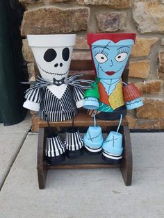 two halloween decorations sitting on top of a wooden chair