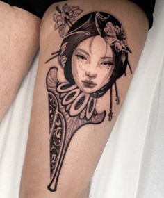 a woman's leg with a clock and flowers on it, as well as a flower in her hair