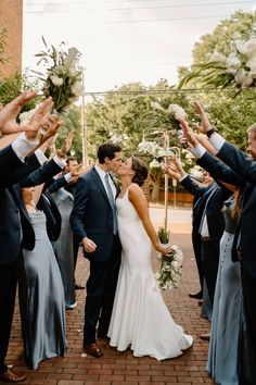 a bride and groom are surrounded by their wedding party