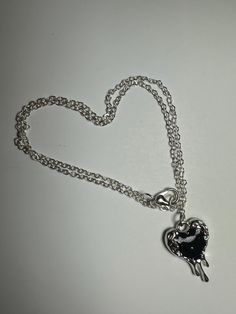 This handmade necklace features a beautiful silver, melted heart pendant. Perfect for everyday wear or special occasions! May not be best suited for water wear* Silver Heart Pendant Necklace With Silver Chain, Silver Heart Bead Pendant Necklace, Silver Open Heart Clavicle Chain Necklace, Silver Heart Pendant Necklace With Heart Beads, Silver Metal Heart Pendant Necklace, Handmade Silver Heart Charm Necklace, Silver Open Heart Metal Necklace, Silver Heart Charm Pendant Necklace, Silver Heart Necklace With Heart Charm Pendant