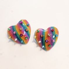 Super cute handmade rainbow studded heart earrings.  Super light handmade earrings with polymer clay and stainless steel posts. Rainbow Heart-shaped Earrings As Gift, Rainbow Heart Earrings For A Gift, Cute Rainbow Jewelry For Pierced Ears, Heart-shaped Rainbow Earrings As Gift, Cute Multicolor Polymer Clay Earrings, Rainbow Heart Earrings As Gift, Rainbow Heart Earrings For Gift, Handmade Heart-shaped Novelty Earrings, Rainbow Polymer Clay Jewelry For Gifts